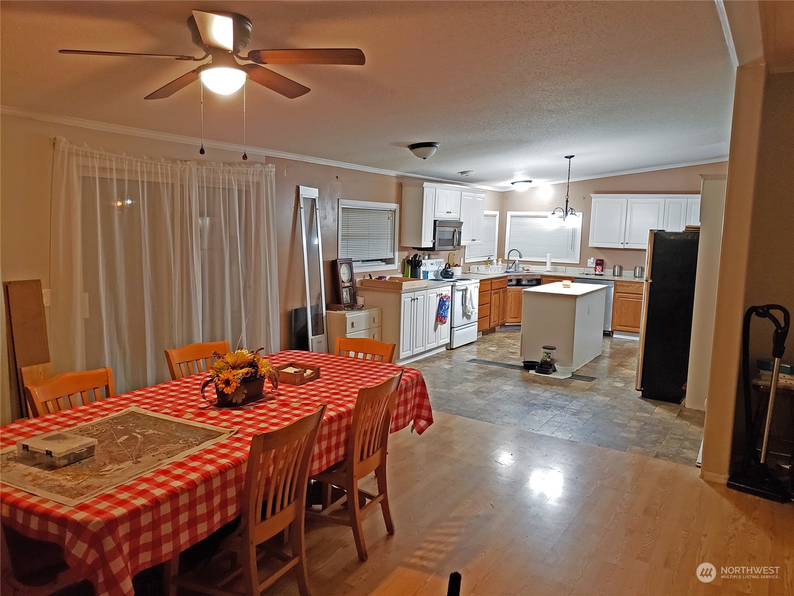 7130 196th Avenue Southwest Rochester, WA 98579 - Photo 7 of 36 a dining room with a table chairs and a refrigerator