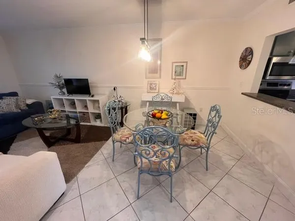 a view of a dining room with furniture and a chandelier
