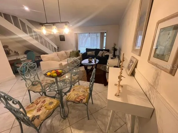 a living room with furniture a flat screen tv and a window