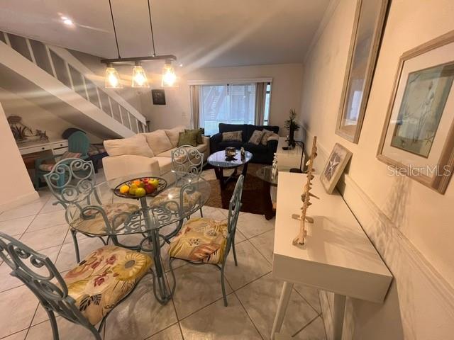1614 Stickney Point Road, Unit 102 Sarasota, FL 34231 - Photo 13 of 34 a view of a dining room with furniture and a chandelier