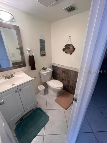 a bathroom with a toilet and a mirror