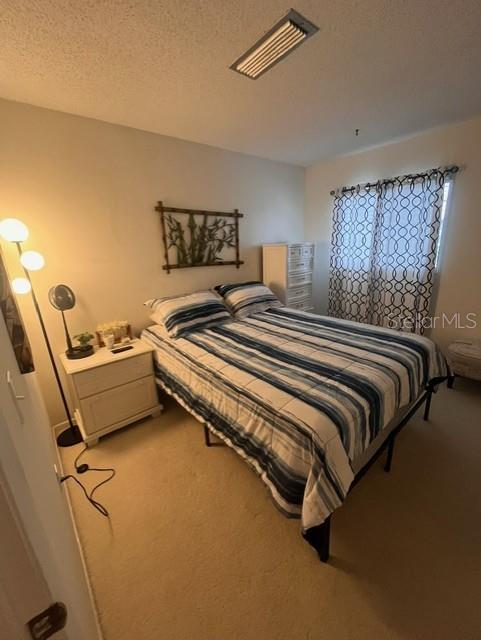 1614 Stickney Point Road, Unit 102 Sarasota, FL 34231 - Photo 22 of 34 a bedroom with a bed and furniture
