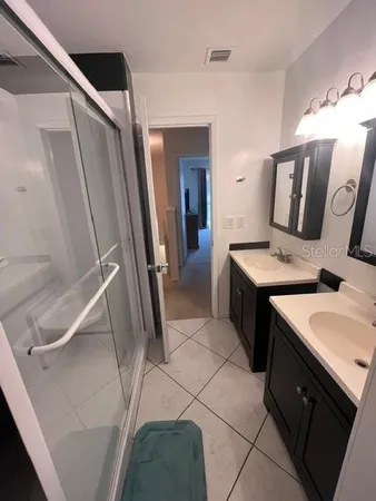 a bedroom with a bed and painting on the wall