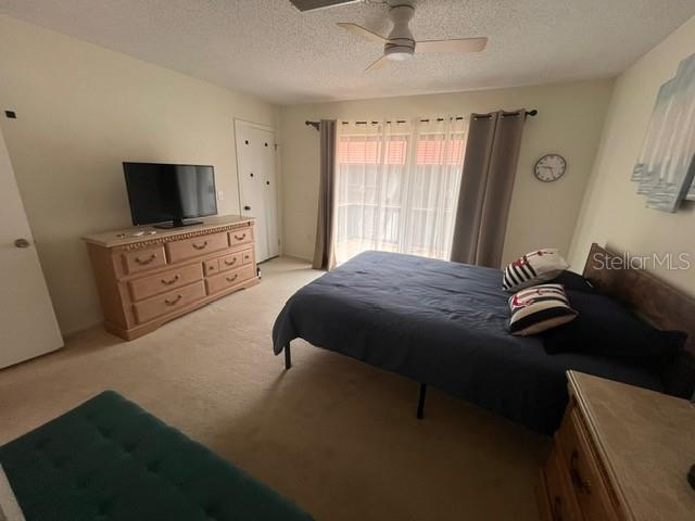 1614 Stickney Point Road, Unit 102 Sarasota, FL 34231 - Photo 27 of 34 a bedroom with a bed and a flat screen tv