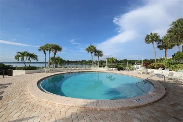 an aerial view of a house with a garden and lake view