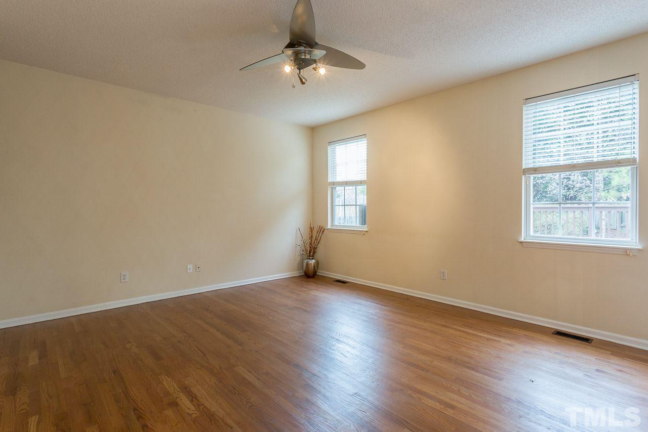 12516 Garden Tree Lane Raleigh, NC 27614 - Photo 11 of 25 a view of an empty room with wooden floor and a window
