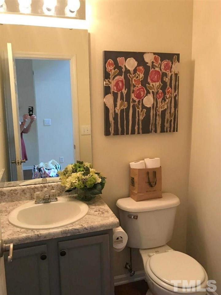 12516 Garden Tree Lane Raleigh, NC 27614 - Photo 13 of 25 a bathroom with a granite countertop toilet sink and mirror