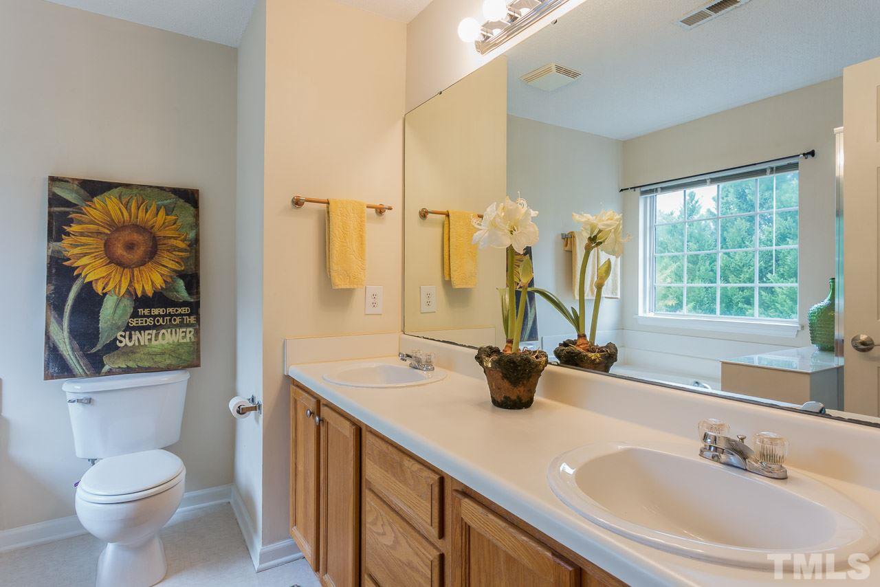 12516 Garden Tree Lane Raleigh, NC 27614 - Photo 14 of 25 a bathroom with a sink a toilet and a mirror