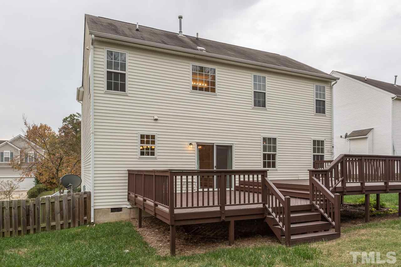12516 Garden Tree Lane Raleigh, NC 27614 - Photo 20 of 25 a view of a house with a wooden deck and a backyard