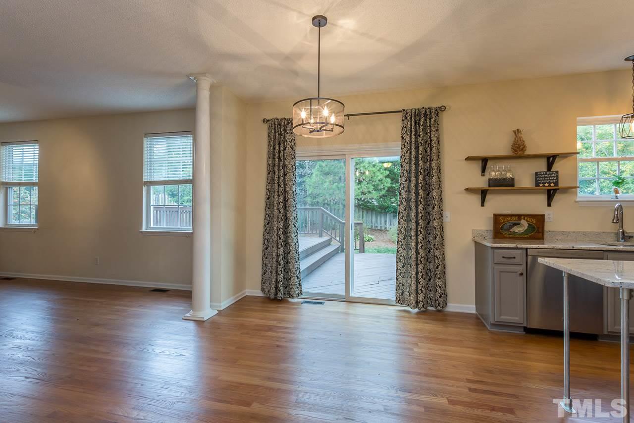 12516 Garden Tree Lane Raleigh, NC 27614 - Photo 3 of 25 a view of a kitchen with stainless steel appliances granite countertop a stove a sink and a wooden floor