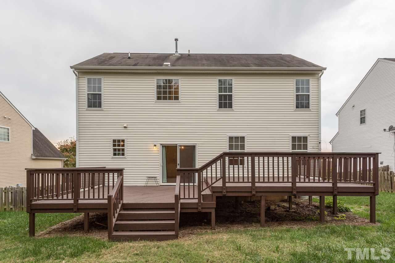 12516 Garden Tree Lane Raleigh, NC 27614 - Photo 21 of 25 a view of a house with wooden deck and furniture
