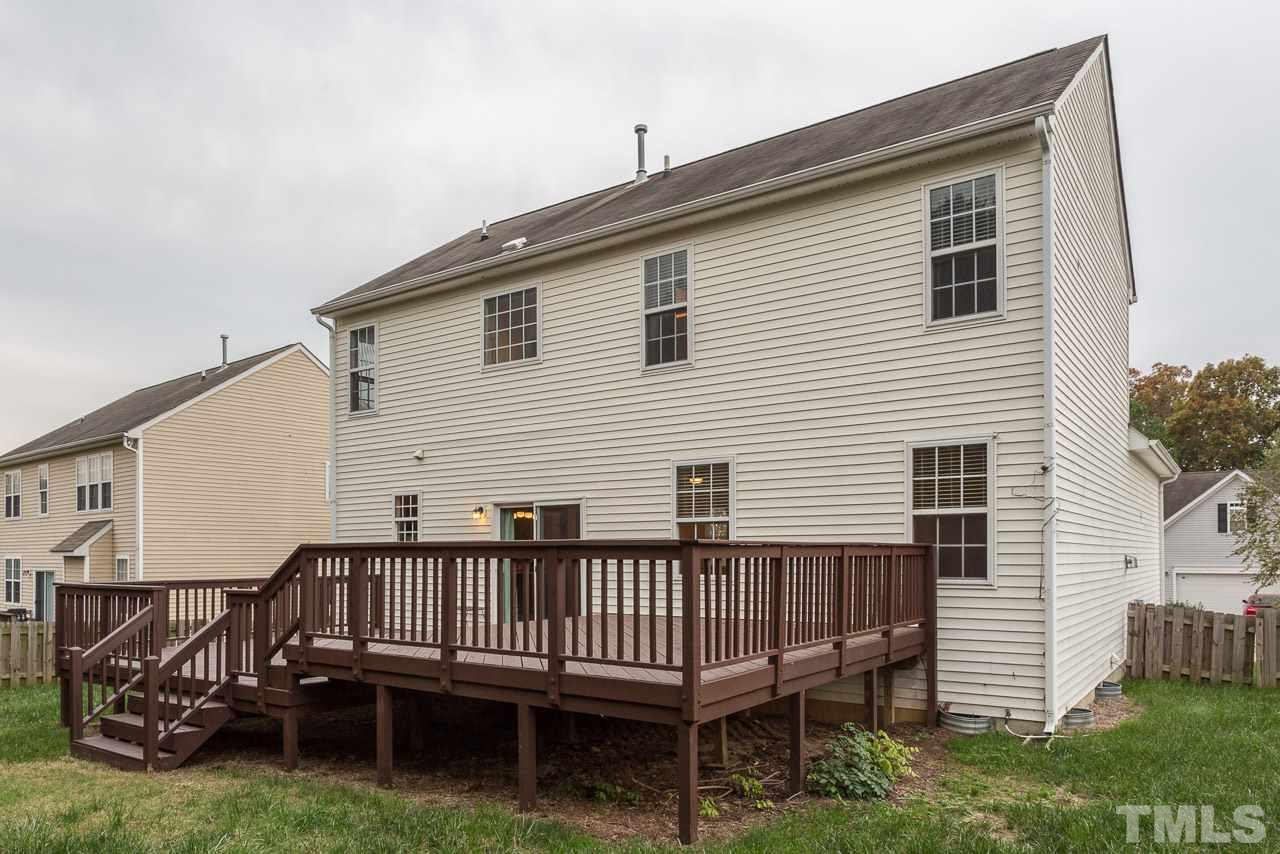 12516 Garden Tree Lane Raleigh, NC 27614 - Photo 22 of 25 a view of a house with a deck and a yard