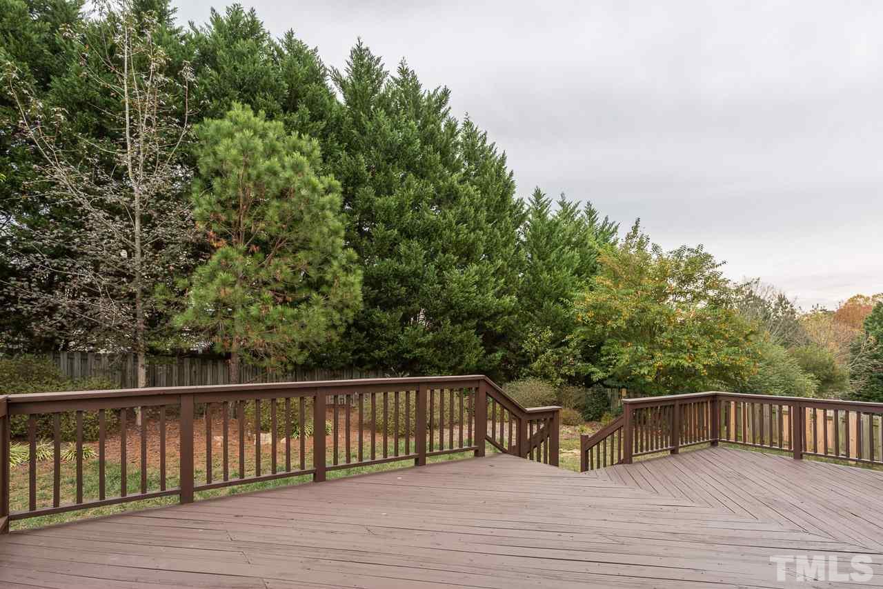 12516 Garden Tree Lane Raleigh, NC 27614 - Photo 4 of 25 a balcony with wooden floor and fence