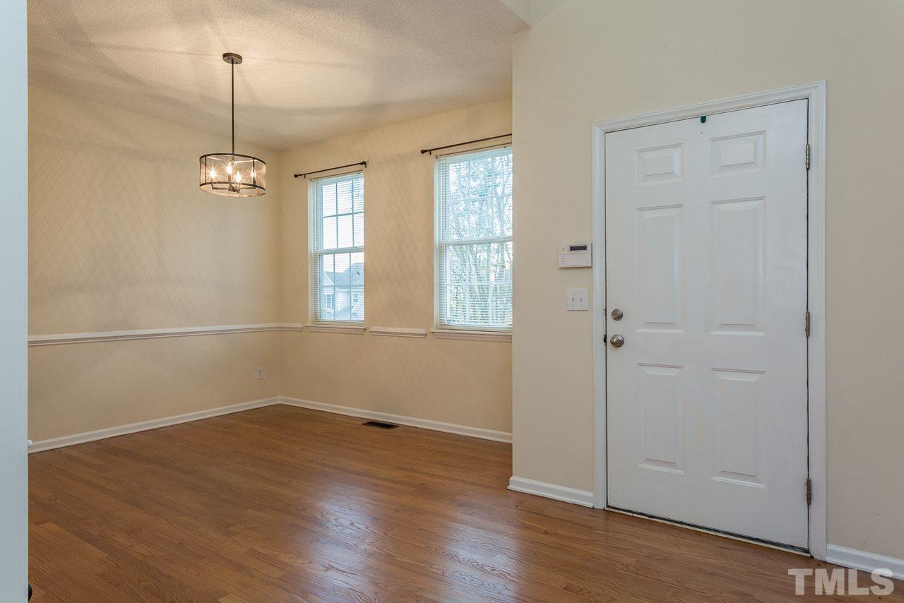 12516 Garden Tree Lane Raleigh, NC 27614 - Photo 7 of 25 an empty room with wooden floor and windows