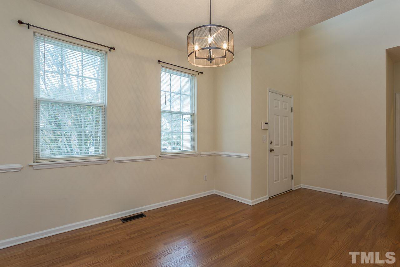 12516 Garden Tree Lane Raleigh, NC 27614 - Photo 8 of 25 an empty room with wooden floor and windows