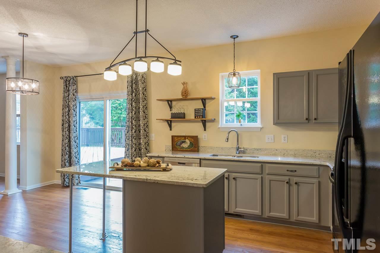 12516 Garden Tree Lane Raleigh, NC 27614 - Photo 9 of 25 a kitchen with a sink stove and refrigerator