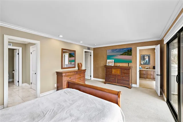 a bedroom with a large bed and balcony