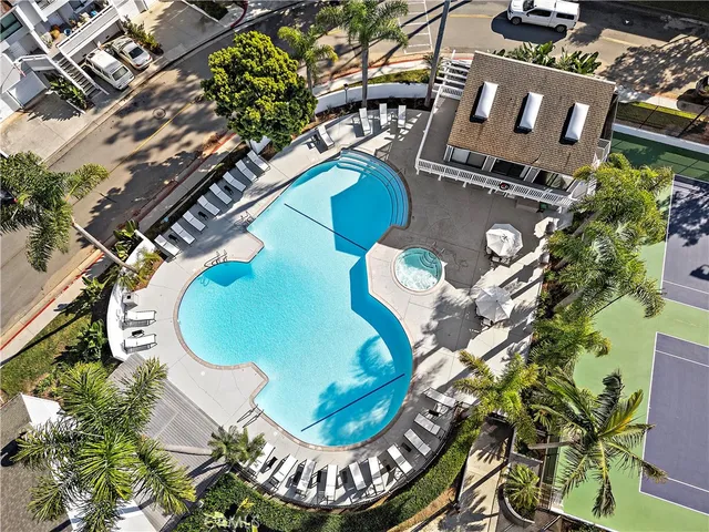 an aerial view of a swimming pool patio and outdoor seating