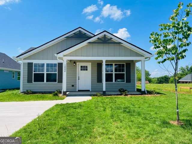 a front view of a house with a yard and porch