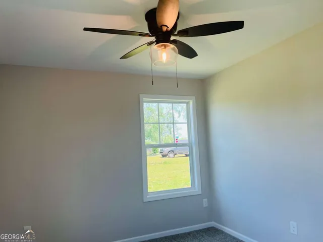 a room with window and a ceiling fan