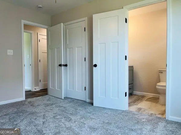 a view of room with a toilet and a sink