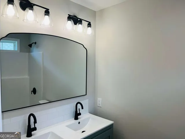 a bathroom with a sink and mirror