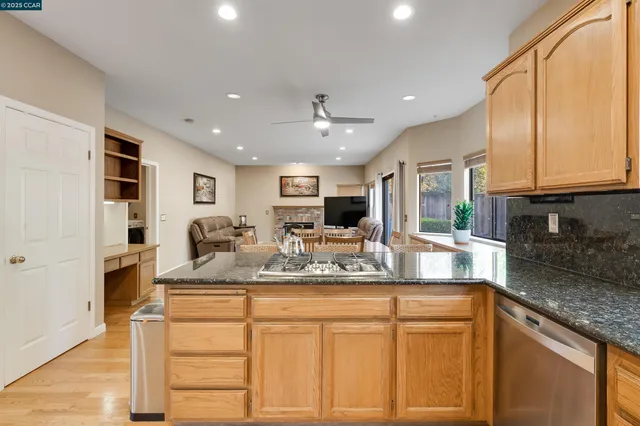 a kitchen with granite countertop a stove a sink and a granite counter tops