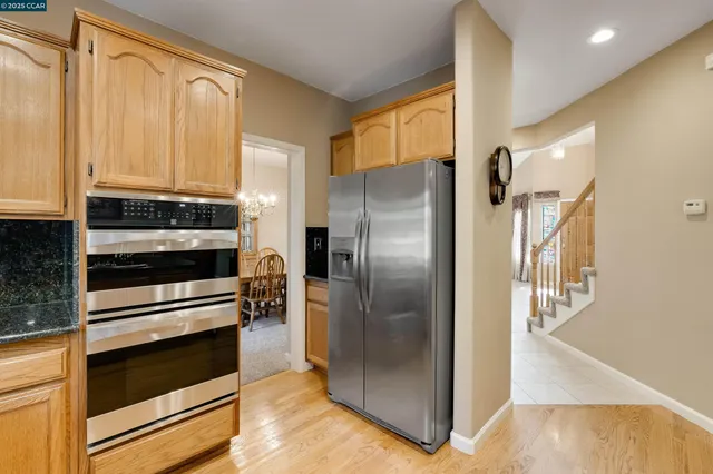 a kitchen with stainless steel appliances granite countertop a sink and cabinets
