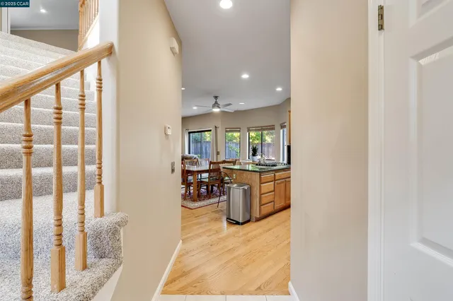 a spacious bedroom with a large bed a fireplace and a chandelier