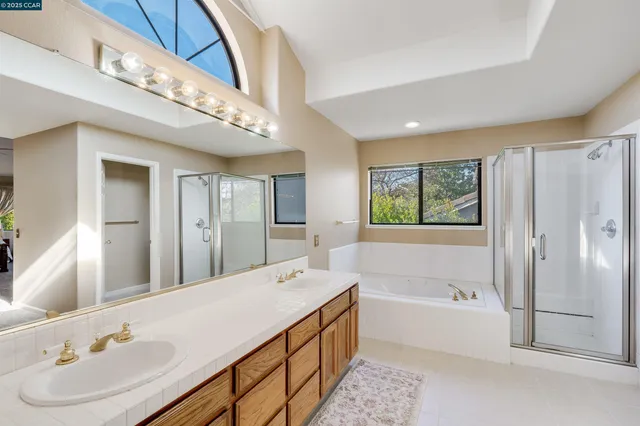 a spacious bathroom with a double vanity sink and a mirror