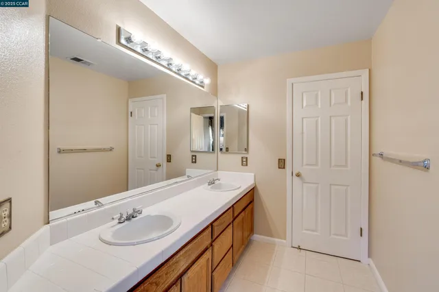 a bedroom with a bed and a flat tv screen on wall