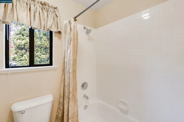 a bed sitting in a room next to a window