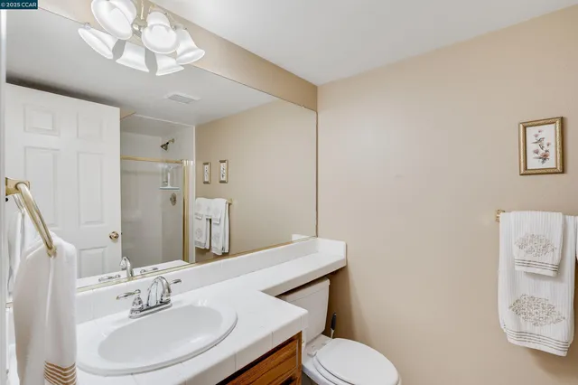 a view of backyard of house with wooden fence