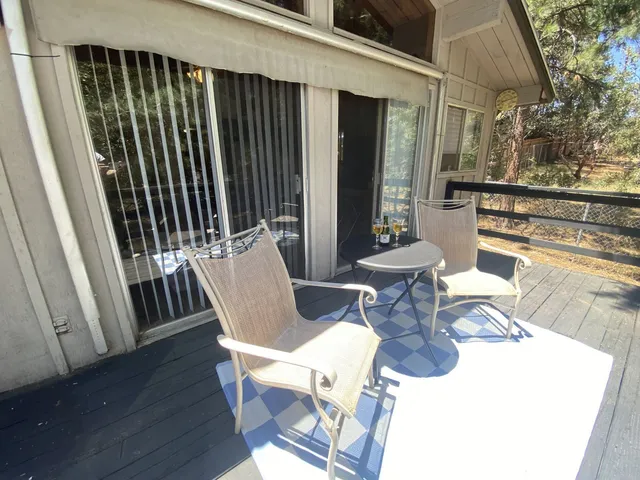 a view of a patio with table and chairs