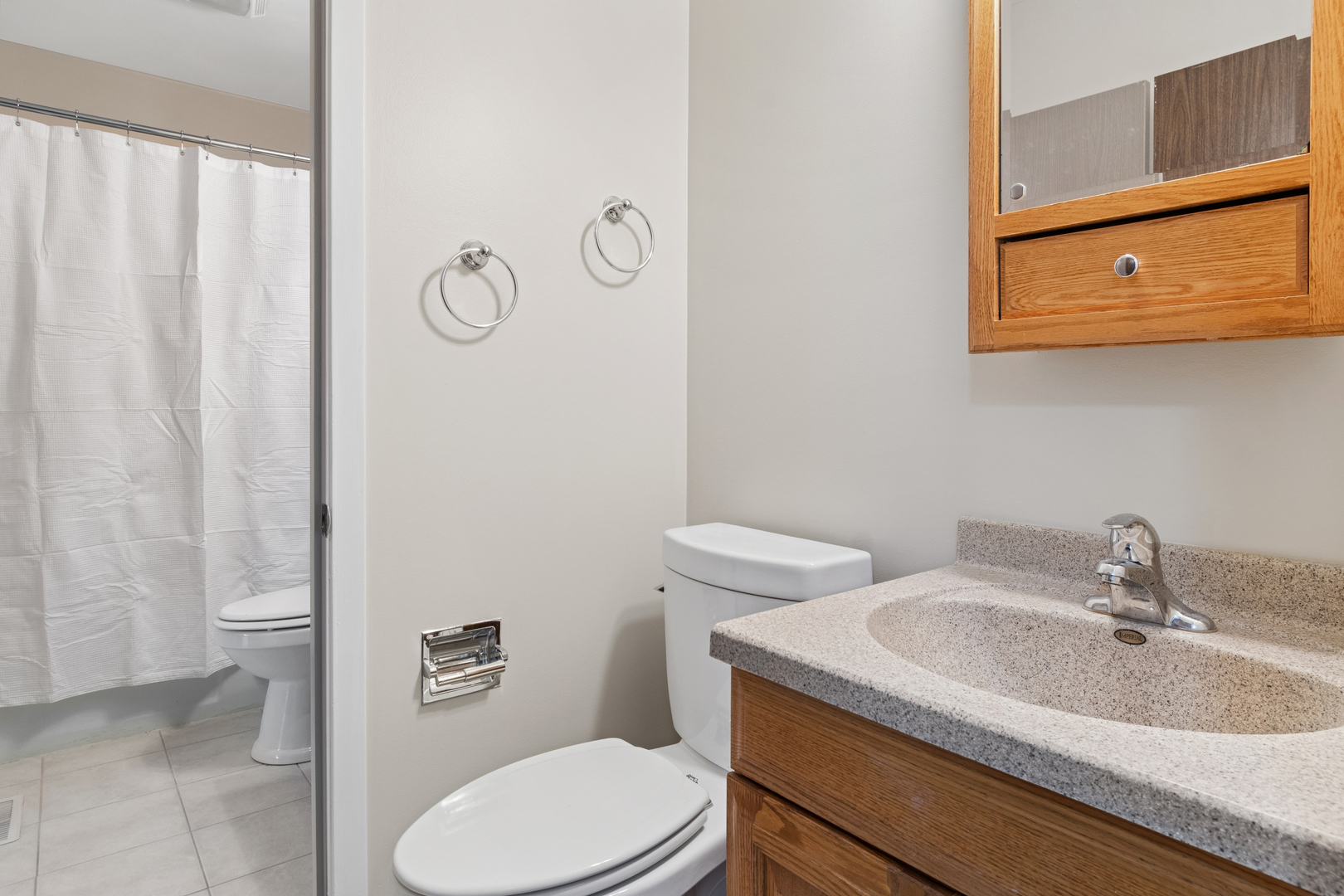 101 Aberdeen Court Geneva, IL 60134 - Photo 13 of 23 a bathroom with a sink a toilet and shower curtain