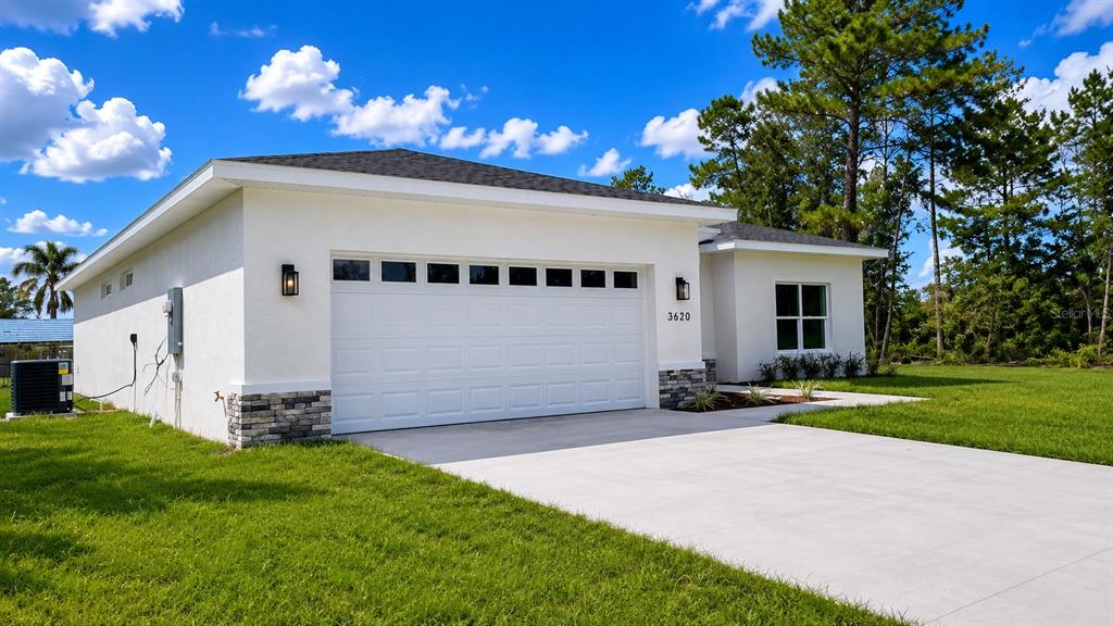 3620 Southwest 127th Lane Road Ocala, FL 34473 - Photo 2 of 23 a front view of a house with a yard