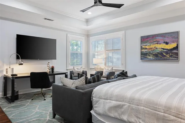 a kitchen with a chair a flat screen tv and windows