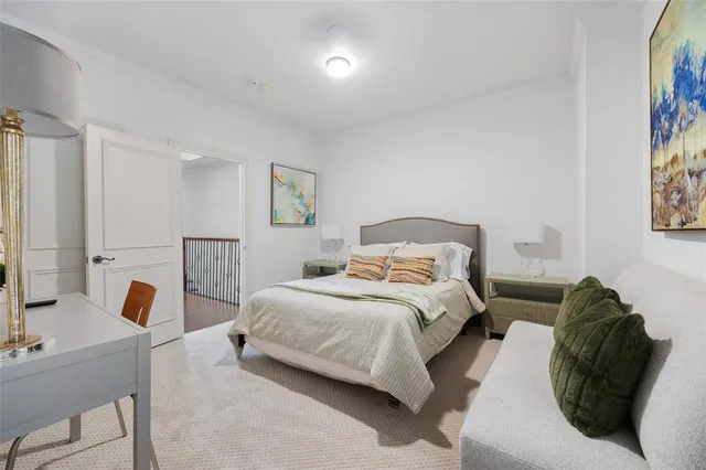 a bedroom with a bed a couch and a window