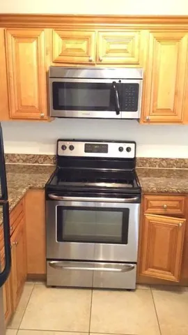 a stove top oven sitting inside of a kitchen