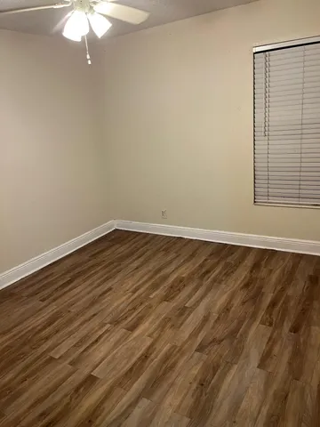 a bathroom with a granite countertop toilet a sink and a mirror
