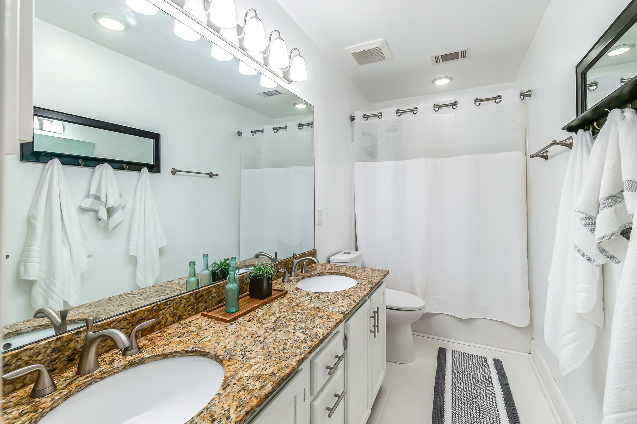 555 Ridgestone Drive Franklin, TN 37064 - Photo 27 of 46 a bathroom with a granite countertop sink a mirror a shower and a bathtub