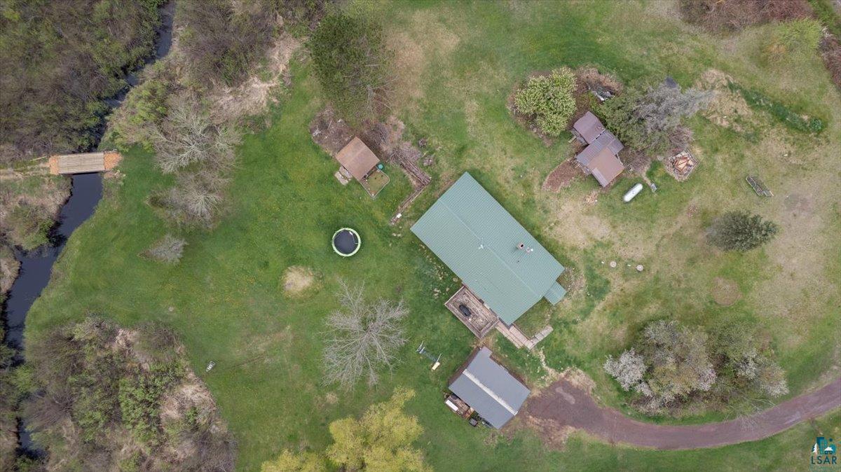 5190 County Road M Gordon, WI 54838 - Photo 31 of 31 Expansive green landscape with a central residence featuring a green metal roof