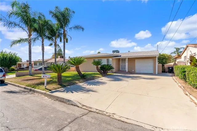 a view of a house with backyard and tree s