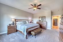 1309 Ridge Pointe Way Blairsville, GA 30512 - Photo 14 of 73 a bedroom with a bed and a chandelier