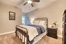1309 Ridge Pointe Way Blairsville, GA 30512 - Photo 17 of 73 a bedroom with a bed and a chandelier