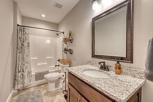 1309 Ridge Pointe Way Blairsville, GA 30512 - Photo 25 of 73 a bathroom with a granite countertop sink toilet and shower