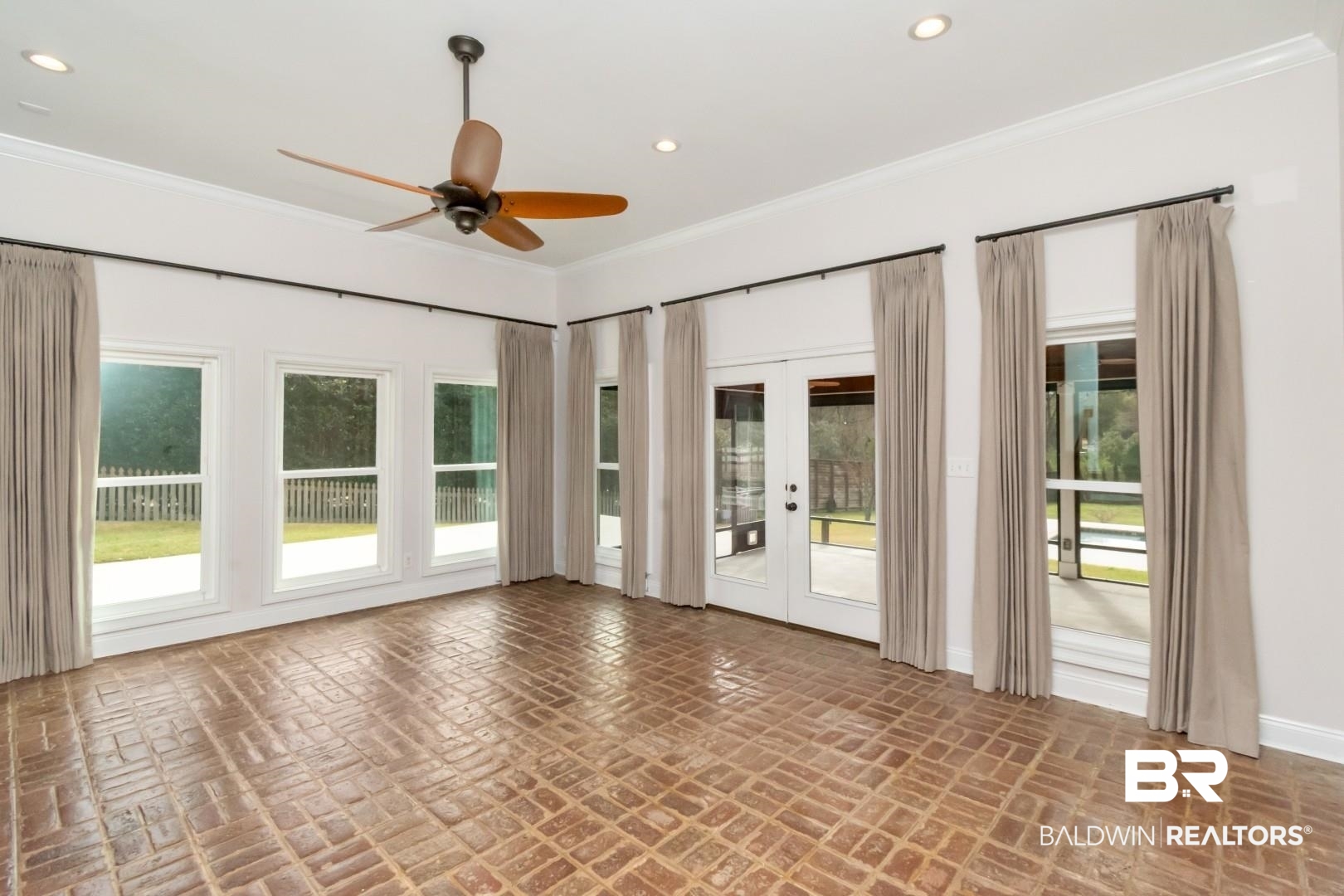 231 Rochester Road Mobile, AL 36608 - Photo 21 of 51 Spare room featuring french doors, ceiling fan, brick flooring, recessed lighting, and crown molding