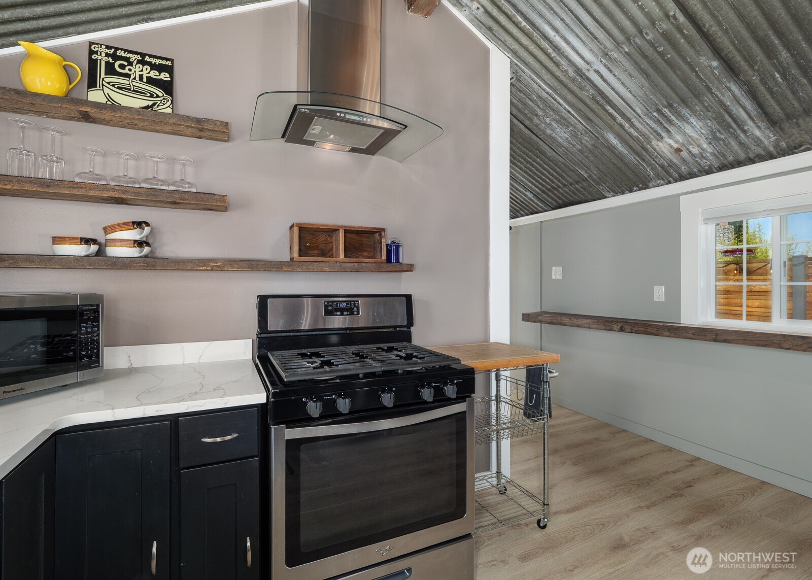 233 West Washington Street Sequim, WA 98382 - Photo 16 of 40 a kitchen with stainless steel appliances a stove a microwave and cabinets