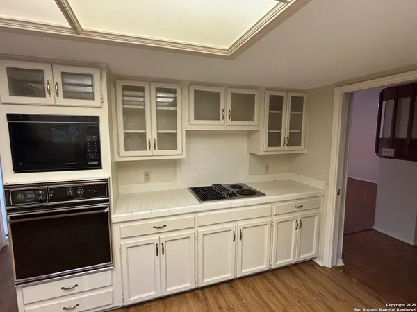 a kitchen with stainless steel appliances granite countertop a stove and a microwave