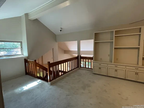 a view of an empty room with windows